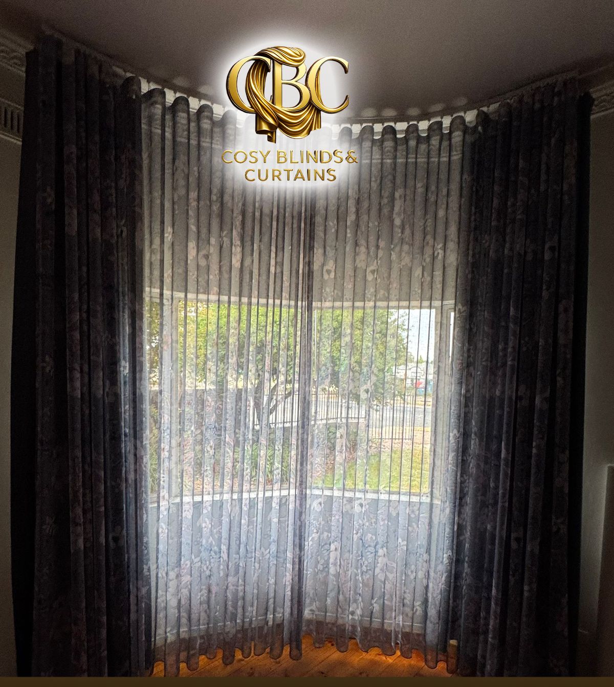 Patterned sheers and blockout drapes on a bay window