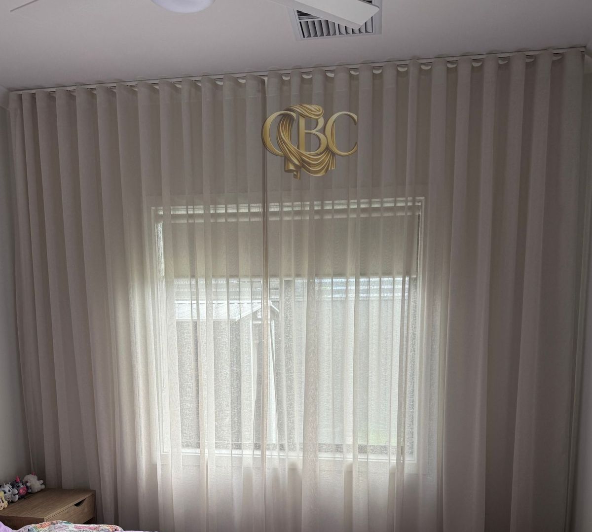 Sheers layered over a blockout roller in a child's bedroom