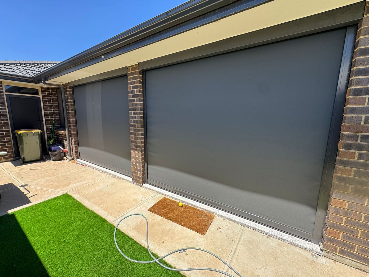 Outdoor blinds enclosing a backyard alfresco