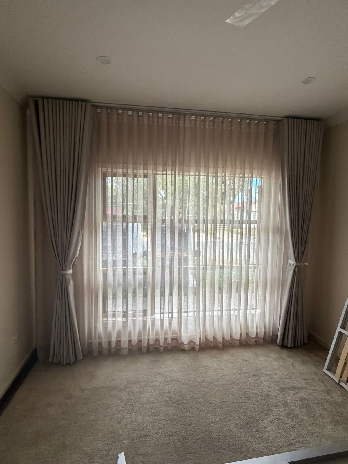 Sheers with blockout drapes, tied back