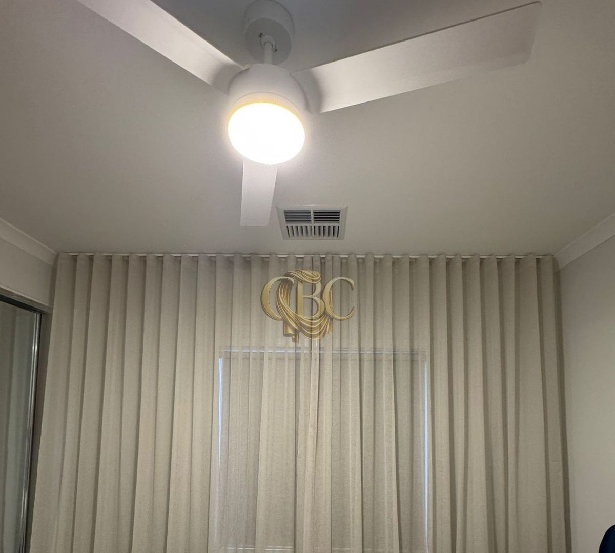 Wave-fold sheers softening a main bedroom