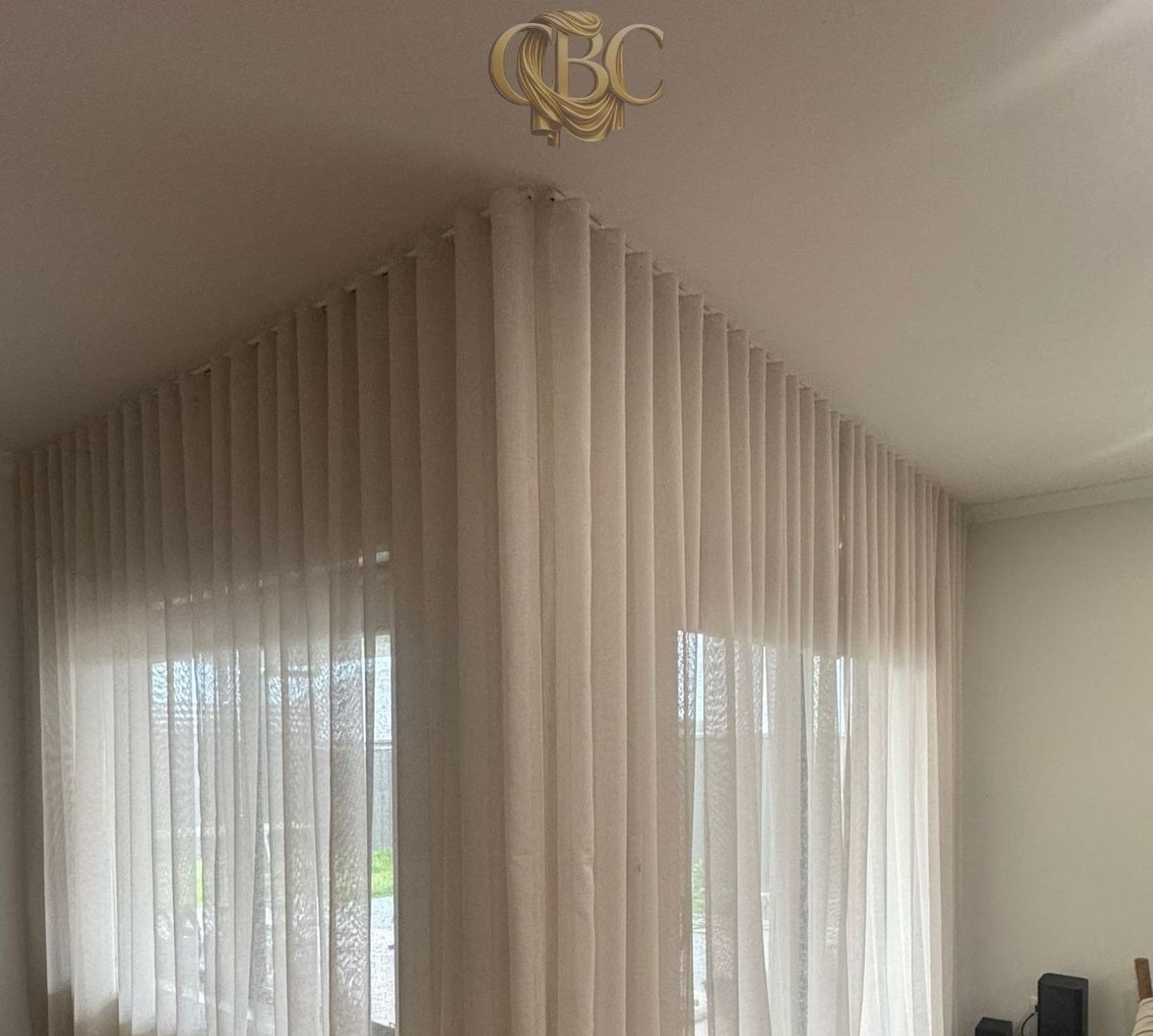 Floor-to-ceiling S-Wave sheers wrapping a corner window